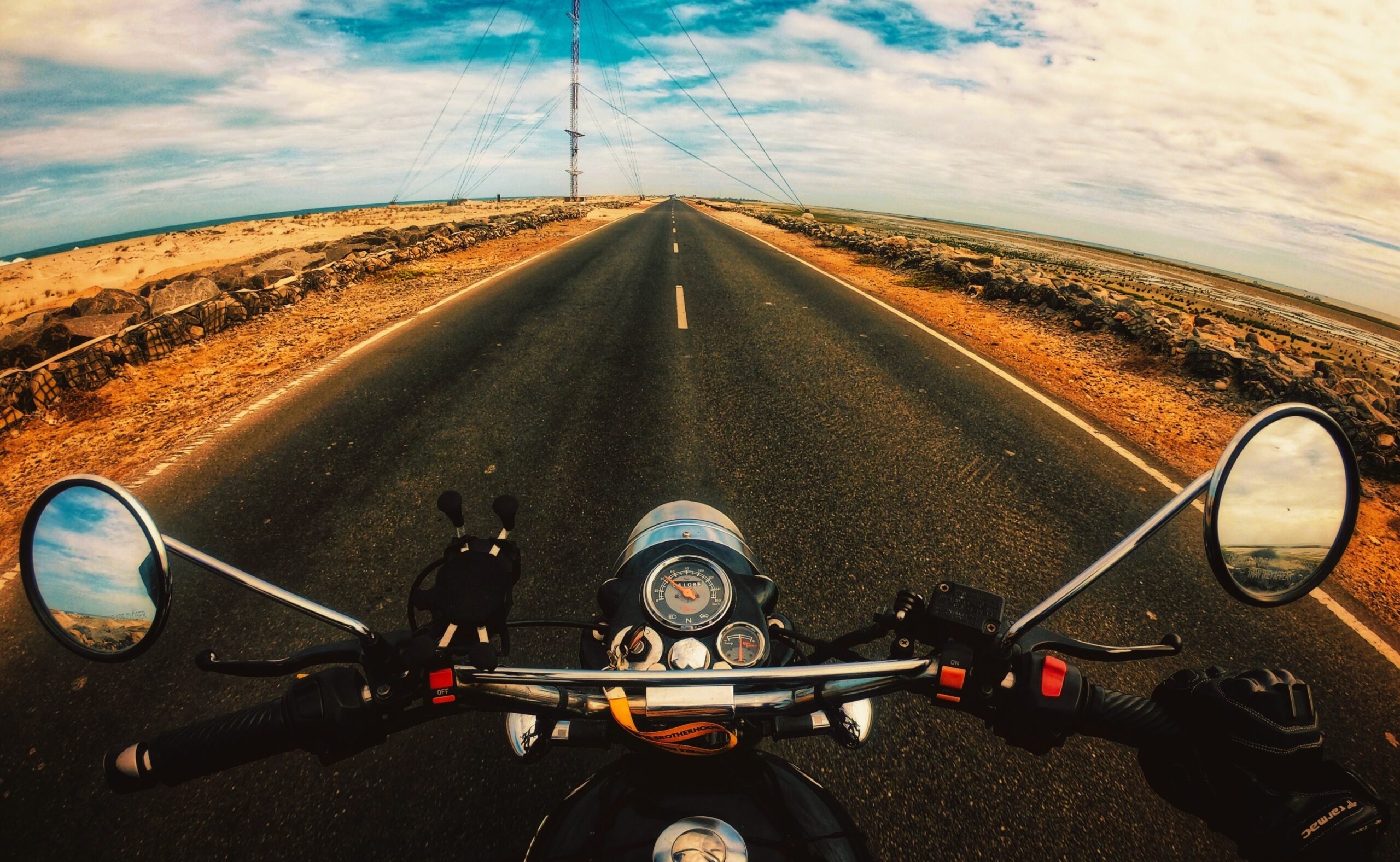 Anonymous biker riding motorcycle on highway in countryside with nice views