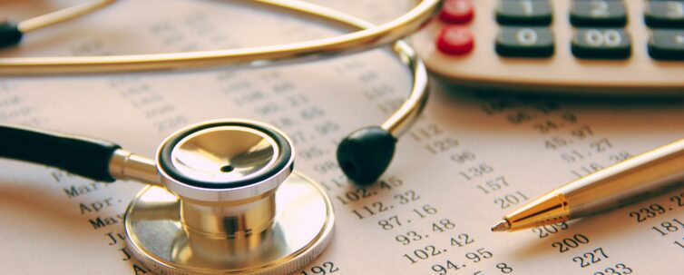 Medical bills, stethoscope call calculator and ballpen