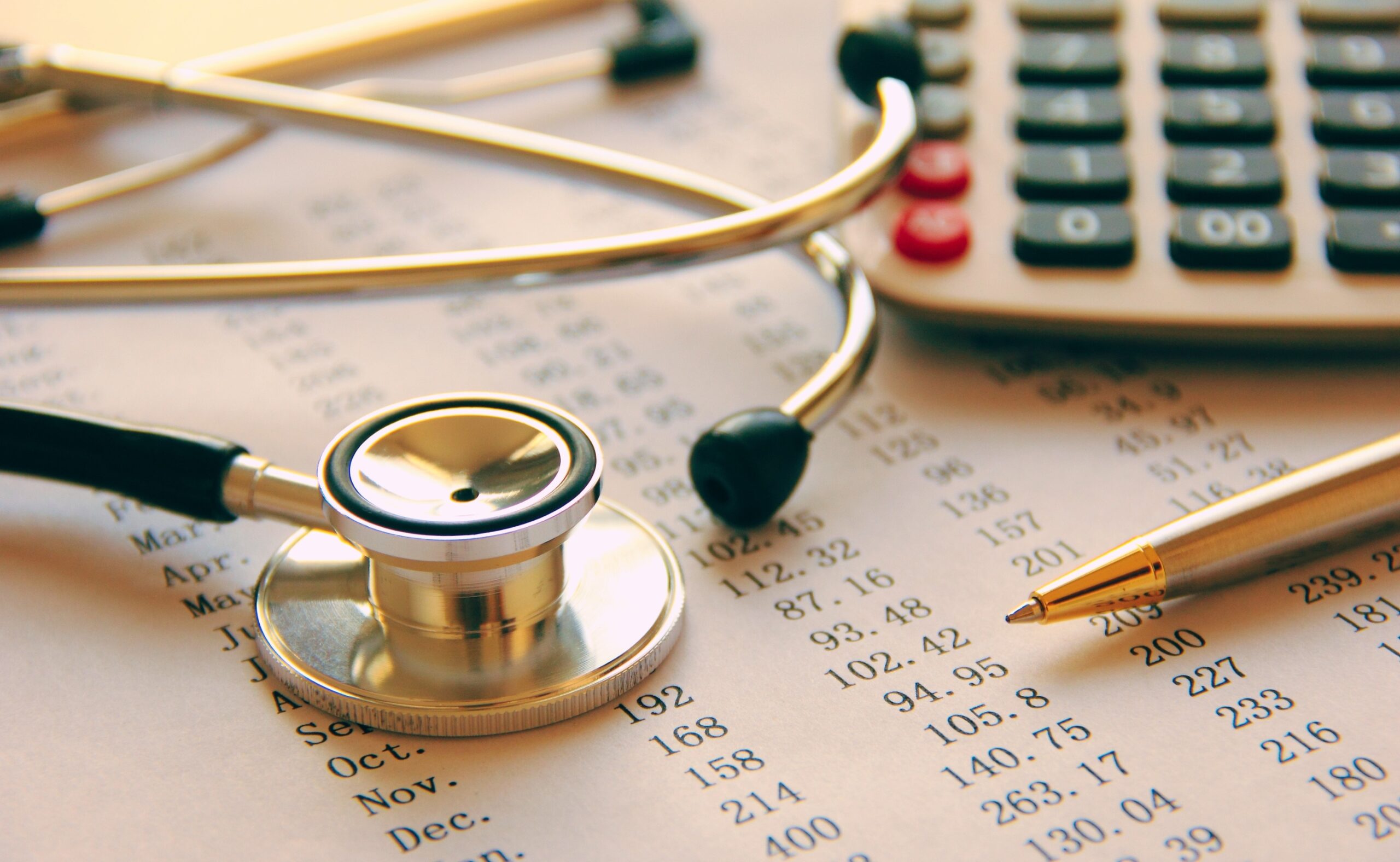 Medical bills, stethoscope call calculator and ballpen