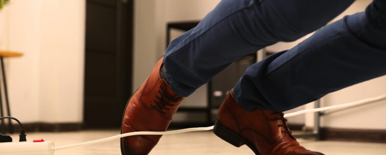 man tripping over cord in the office