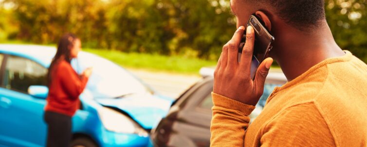 Man involved in a car accident calling insurance company or recovery service