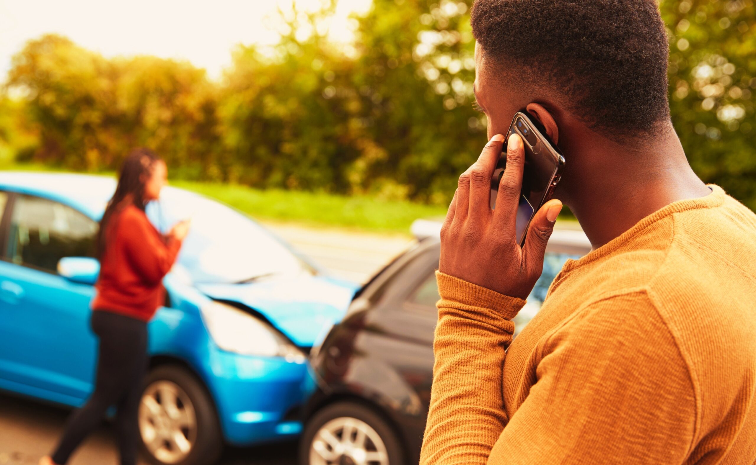 Man involved in a car accident calling insurance company or recovery service