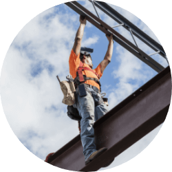 Construction worker standing on a beam