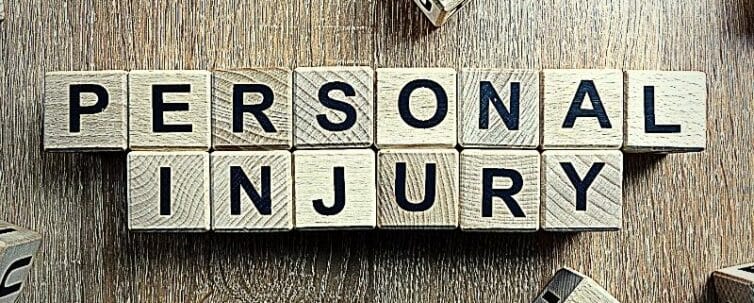 Personal injury text from wooden blocks on desk
